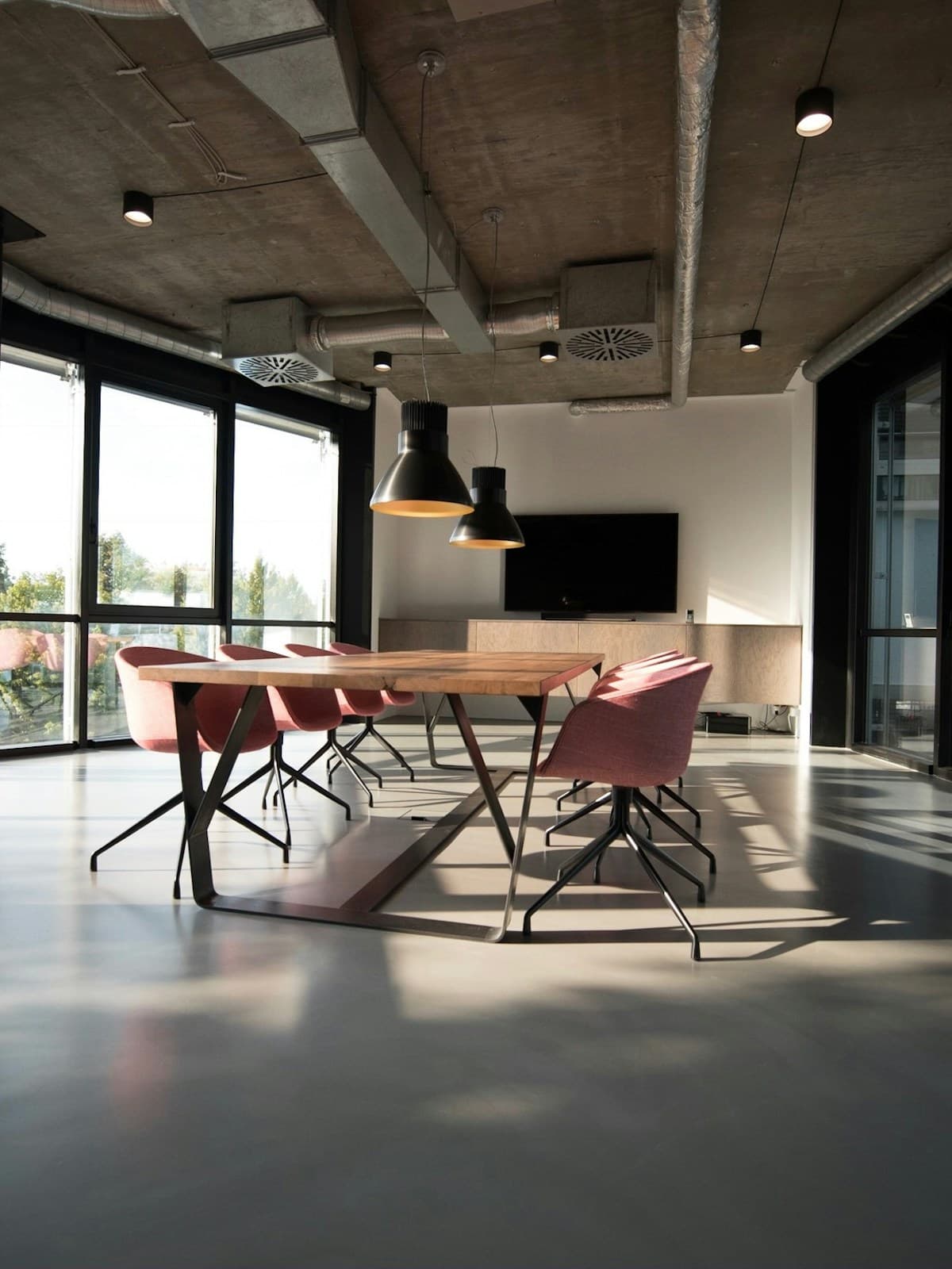 Empty walnut conference table in a bright minimalist office